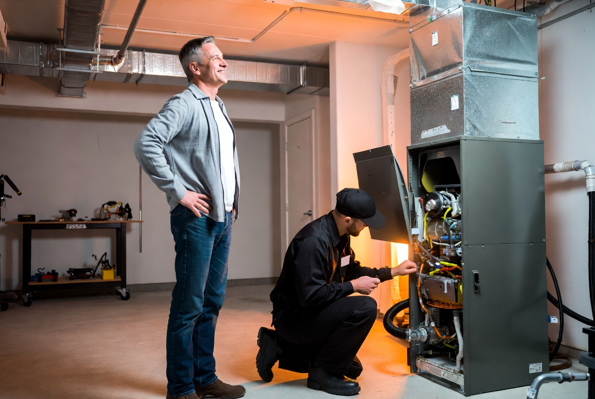 Professional technician repairing home appliance with homeowner